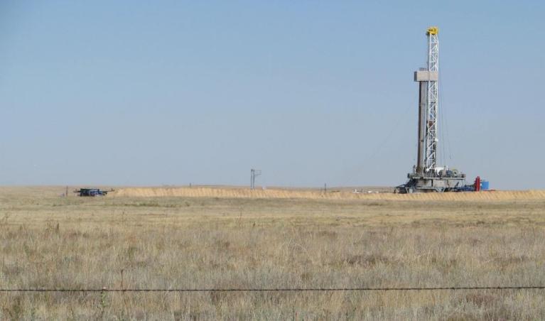 photograph of an oil gas extraction rig located in a rural field